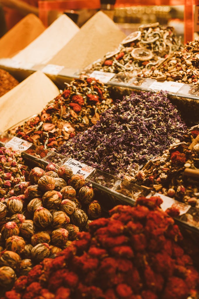 Colorful assortment of dried herbal teas beautifully arranged at a market stall, showcasing a variety of textures and colors.